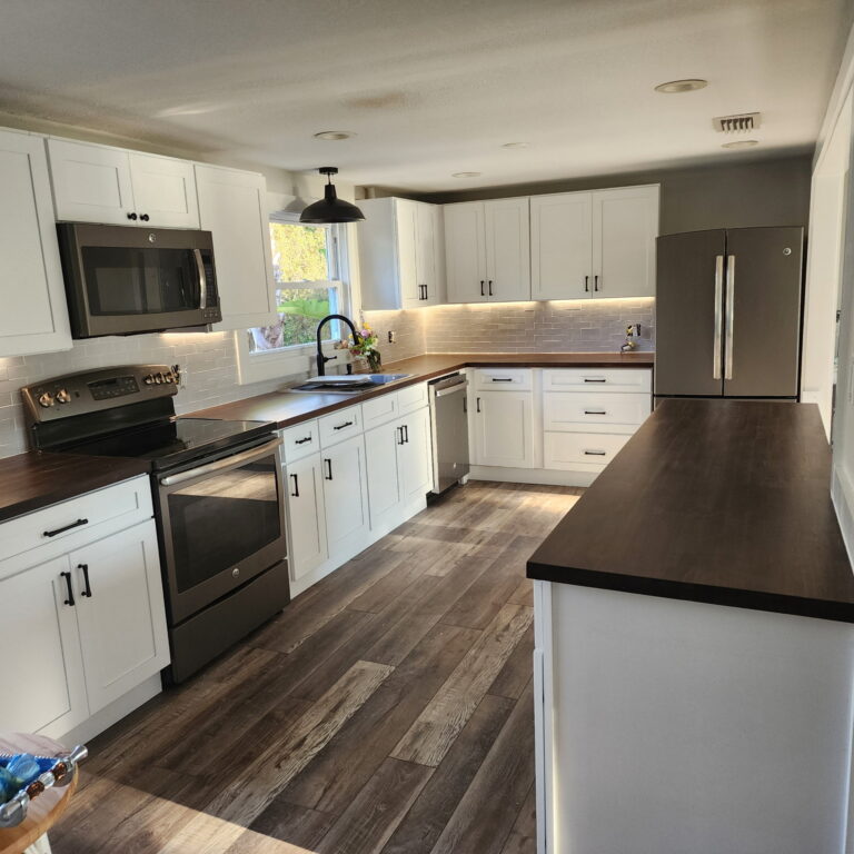 White shaker kitchen cabinets with butcher block countertops and subway tile backsplash in Jacksonville, FL