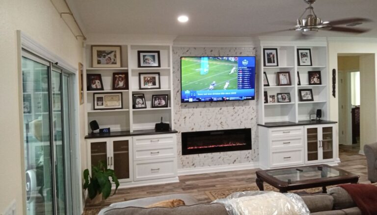 Custom built-in entertainment center with shelving and electric fireplace installed in Jacksonville, Florida