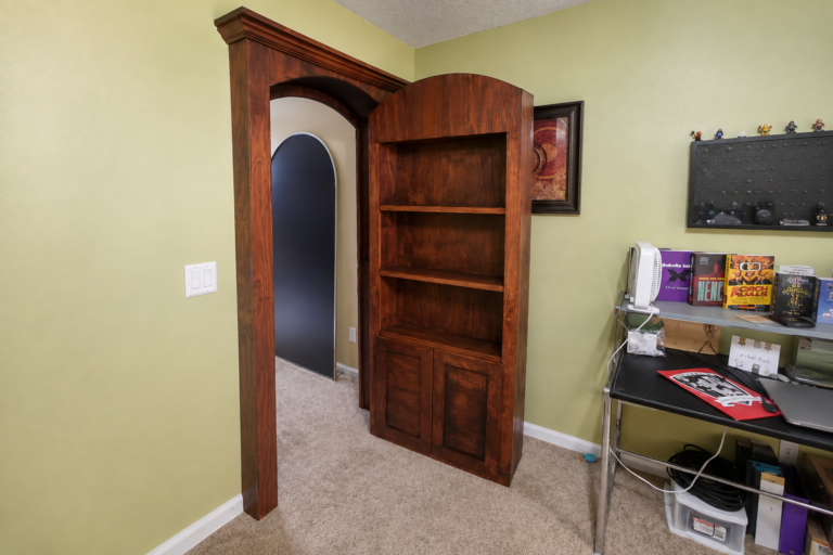 Custom hidden bookcase door with built-in shelving